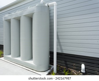 Rainwater Collection Tank Besides A Modern House