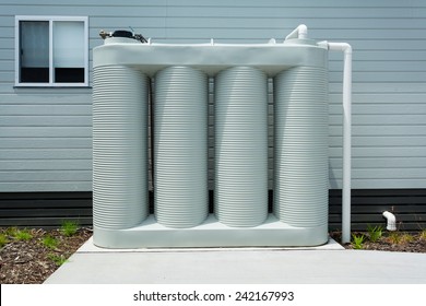 Rainwater Collection Tank Besides A Modern House