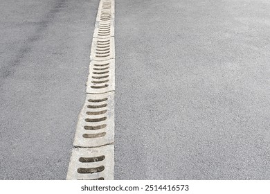 Rainwater drainage system on asphalt road.	 - Powered by Shutterstock