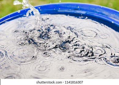 Rainwater harvesting in a large polymer tank on the terrace of a house. Ripples on the surface of water. Aquaphobia - fear of water.