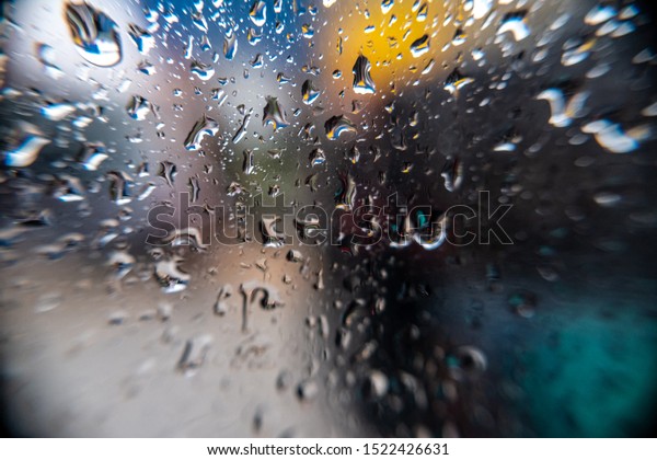 Rainwater\
is stuck on car clear glass on heavy rain\
days