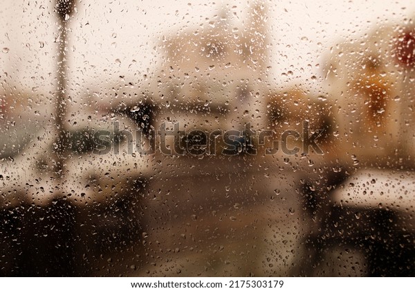 Rainy city\
background. Raindrops on window glass on autumn day. Wet home\
window with raindrops. High quality\
photo.