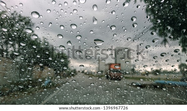 rainy day on the road , rain falling make car stop\
and slowly