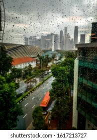 Rainy Day In Singapore, A View Out Of An Office Building Window Covered In Raindrops