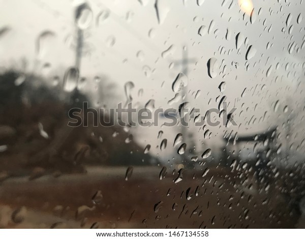 In rainy day, I took this\
photo inside my car. It was little bit cold outside. It was autumn\
rain.