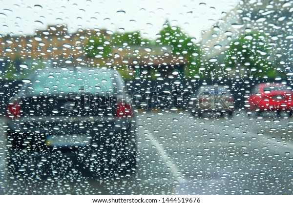 Rainy days. Driving in rain, rainy weather. Rain\
drops on window.