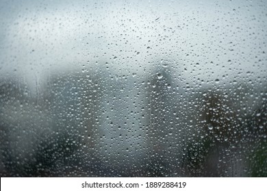 Rainy Drops On Window Glass With Blurry Building Background