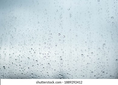 Rainy Drops On Window Glass With  Sky Background
