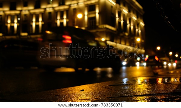 Rainy night in the big city, the car\
traveling on the highway and shines a blinding\
light.