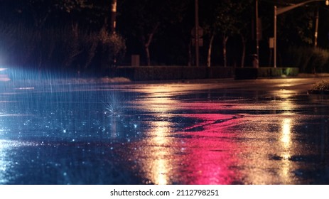 Rainy night in city, the rain was illuminated by the headlights of car. - Powered by Shutterstock