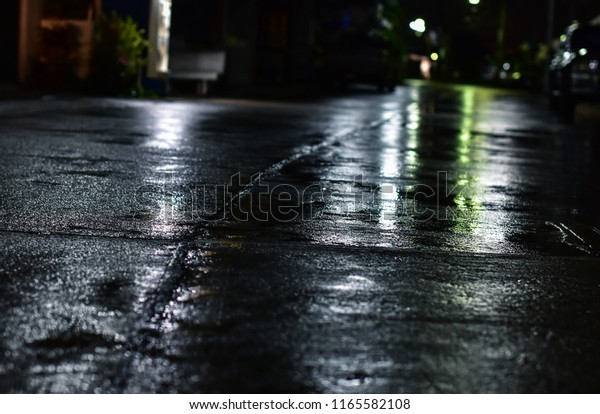 Rainy night on the\
cement floor in the night