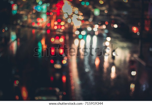 rainy night traffic,motion blur and bokeh\
effect viewed from the road bridge,udon thani, Thailand.night\
cityscape,cinematic photography with film\
grain