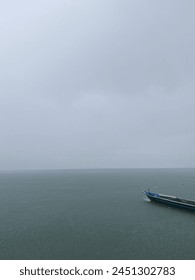 rainy ocean with boat and tree objects