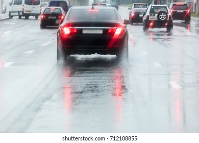 Rainy Road. Driving Cars On A Wet Street With Splashing Water In Motion Blur. 