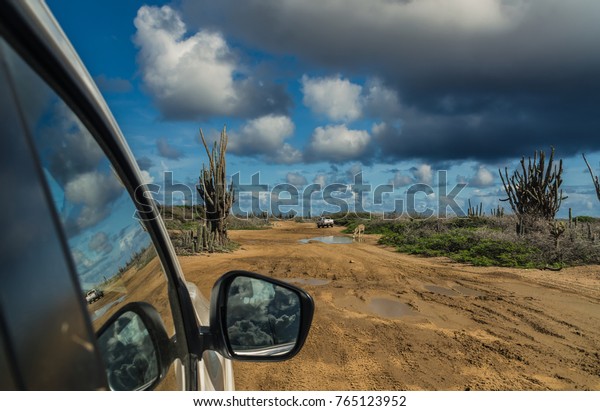 Rainy season at Bonaire\
and visit to the rough east coast. Some miles further we got stuck\
in the mud.