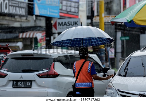 Rainy Season Parking Attendant Uses Umbrella Stock Photo Edit Now