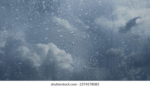 Rainy sky behind window glass. Gloomy and bad weather. - Powered by Shutterstock