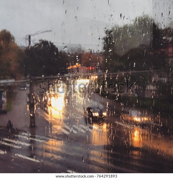 Rainy street with cars\
trough window
