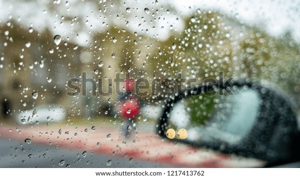 rainy weather, autumn time. drops on the vehicle\'s\
windows and blurry effect. rainy season and cold and cool weather.\
drops of rain on glass.