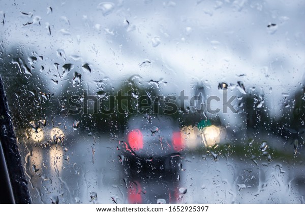 Rainy\
weather. Background of cars from a fogged\
window