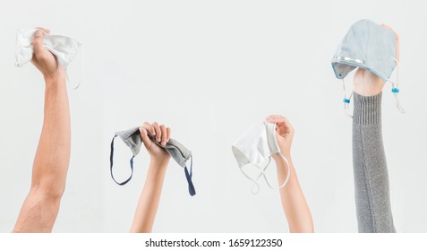 Raise the hand holding the mask isolate on a white background. Promoting people use  to protect themselves from virus infection in Corona virus crisis 2020. - Powered by Shutterstock