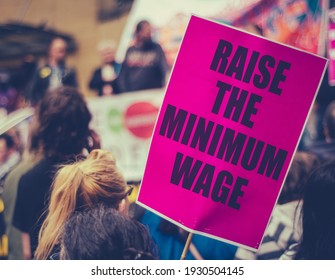 A Raise The Minimum Wage Sign At Worker's Rights Protest Or Rally