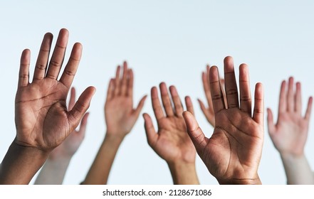Raise your hands as one. Shot of a group of hands reaching up against a white background. - Shutterstock ID 2128671086