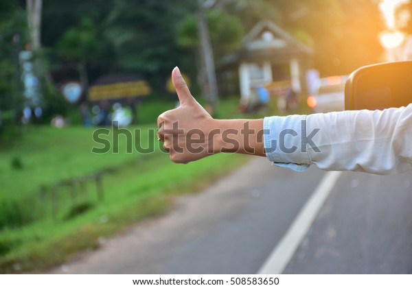 Raise your thumb out of the\
car.