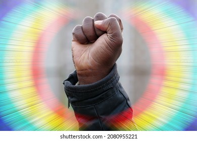 Raised Black Man Fist In Protest, Rainbow Around Fist. Fist Of African American, Social Justice And Peaceful Protesting Racial Injustice. Black Lives Matter, BLM. Mass Protests Against Racism In USA