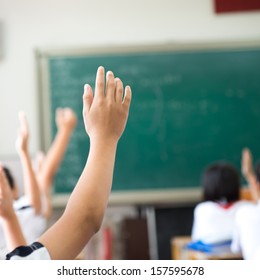 Raised hands in class of middle school. - Shutterstock ID 157595678
