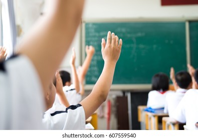 Raised Hands In Class Of Middle School.