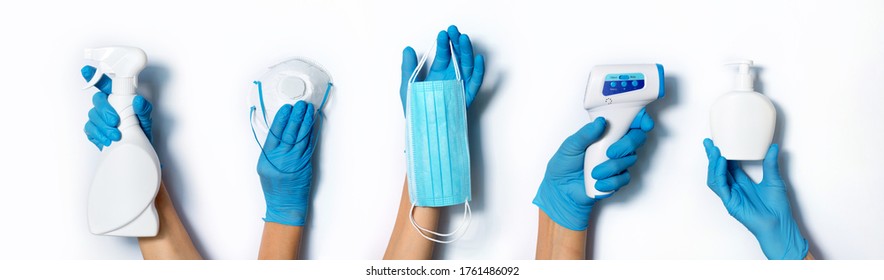 Raised hands in medical gloves holding masks, sanitizers, soap, non contact thermometer on white background. Banner. Copy space. Health protection equipment during quarantine Coronavirus pandemic. - Powered by Shutterstock