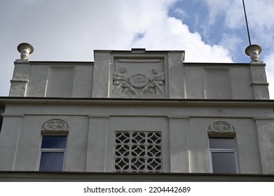 The Raised And Relief-decorated Parapet Of The Facade Of The Historical Building