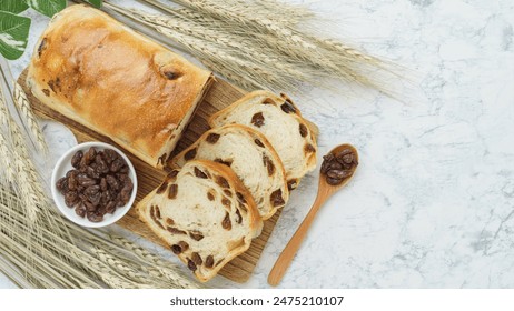 Raisin bread and wheat ears. Bread on a marble table. - Powered by Shutterstock