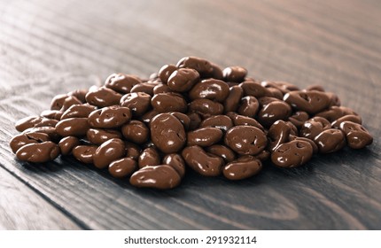 Raisin With Chocolate On Wood Background