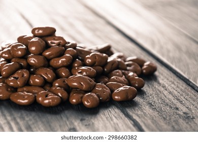 Raisin With Chocolate On Wood Background