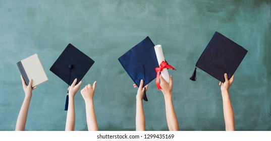 Raising Hands With Graduation Cap On Chalk Board