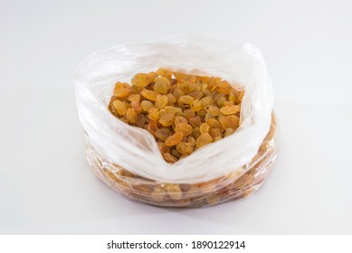 raisins in a plastic bag on a white background.
