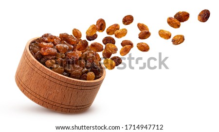 Raisins in wooden bowl isolated on white background with clipping path