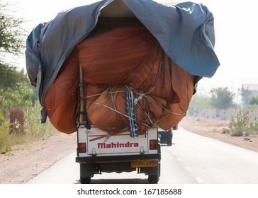 RAJASTHAN, INDIA - CIRCA FEBRUARY 2011: Common Practice Of Loading A Pickup Truck To The Max And Driving It On The Road.