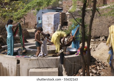 RAJASTHAN, INDIA - FEB. 25: Washing day in an Indian village. Women and children wash cloth by hand in a public well on February 25, 2010 in Rajasthan, India.