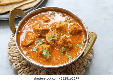 Rajasthani Gatta Curry or Besan Ke Gatte Ki Sabzi. Gatte are gram flour roundels or chickpea flour dumplings are cooked in a spicy, tangy yogurt based curry. delicacy of Rajasthan, India. copy space.