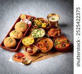 Rajasthani Traditional Cuisine Dal Baati Also Know as Dal Bati or Daal Baati Churma on Grey Background. It is popular in Rajasthan, Uttar Pradesh and Madhya Pradesh.