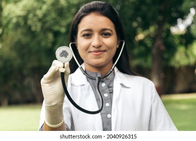 Rajkot, Gujarat, India - Circa 2021: Portrait Of Confident Happy Indian Female Doctor Showing Stethoscope To Camera And Giving Smile. Cardio Checkup To Prevent Heart Attack. Concept Of Healthcare