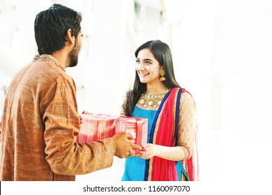 Raksha Bandhan (rakhi, Rakshabandhan) Concept. Indian Brother Giving Gift To His Sister