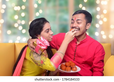 Raksha Bandhan, Sister Feeding Laddoo To Her Brother. Celebrated In India As A Festival Denoting Brother-sister Love And Relationship.