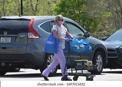 Raleigh, NC/United States- 04/07/2020: A Healthcare Worker Wearing Scrubs And A Face Mask Leaves A Grocery Store Amid The COVID-19 Pandemic. 