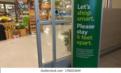 Raleigh, NC/United States- 04/08/2020: A Sign At The Entrance Of A Grocery Store Advises Customers To Stand At Least 6 Feet Apart Amid The Coronavirus Pandemic. 