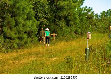 Raleigh, North Carolina USA-09 25 2022: Two People In Wide-Brimmed Hats Walk On The Trails At Williamson Preserve.