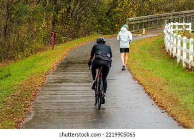 Raleigh, North Carolina USA-10 29 2022: Despite Rain People Enjoy Running And Cycling On The Neuse River Trail.